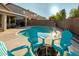 Backyard featuring a refreshing pool, fire pit, lounge chairs, and covered patio seating area at 12374 W Hopi St, Avondale, AZ 85323