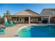 Backyard pool featuring a covered patio with furniture, and steps leading into the water at 12374 W Hopi St, Avondale, AZ 85323