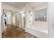 Bright bathroom features a soaking tub, shower with glass door, and neutral decor at 12374 W Hopi St, Avondale, AZ 85323