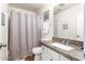 Neutral bathroom featuring a vanity with a granite countertop and a shower with a curtain, creating a functional space at 12374 W Hopi St, Avondale, AZ 85323