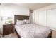 Relaxing bedroom featuring a patterned headboard, soft bedding, and a bedside table with decor, providing a cozy feel at 12374 W Hopi St, Avondale, AZ 85323