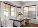 Bright breakfast nook with booth seating, wood floors, and charming window accents at 12374 W Hopi St, Avondale, AZ 85323