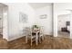 Bright dining room with wood-look tile flooring and a six-seater wooden table with upholstered chairs at 12374 W Hopi St, Avondale, AZ 85323