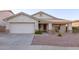 Inviting single-story home featuring a two-car garage, desert landscaping, and a cozy front porch at 12374 W Hopi St, Avondale, AZ 85323