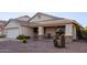 Inviting home featuring a covered front porch with seating and low-maintenance desert landscaping at 12374 W Hopi St, Avondale, AZ 85323