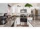 Updated kitchen featuring granite countertops, stainless appliances, and modern cabinetry at 12374 W Hopi St, Avondale, AZ 85323