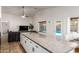 Open kitchen with granite counters, an island with seating, and views of the pool at 12374 W Hopi St, Avondale, AZ 85323