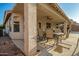 Covered patio area with an outdoor dining set, ceiling fan, and neutral tones for entertaining and relaxation at 12374 W Hopi St, Avondale, AZ 85323