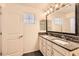 Bright bathroom with a double sink vanity, granite countertop, and elegant fixtures at 128 E Bluejay Dr, Chandler, AZ 85286