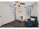 Bedroom with crib, dark green accent chair, and soft carpet at 128 E Bluejay Dr, Chandler, AZ 85286