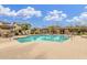 Large community pool surrounded by lounge seating and desert landscaping at 128 E Bluejay Dr, Chandler, AZ 85286