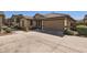 Single-story home with desert landscaping, concrete driveway, and attached garage at 128 E Bluejay Dr, Chandler, AZ 85286