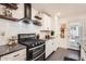 Modern kitchen features stainless steel appliances, granite countertops, and stylish floating shelves at 128 E Bluejay Dr, Chandler, AZ 85286