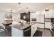 Open-concept kitchen boasts a large island with granite countertops and a dining area at 128 E Bluejay Dr, Chandler, AZ 85286
