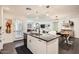 Open-concept kitchen with a granite island, modern appliances, and plenty of natural light at 128 E Bluejay Dr, Chandler, AZ 85286