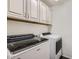 Bright laundry room with washer, dryer, and cabinetry for storage at 128 E Bluejay Dr, Chandler, AZ 85286
