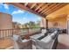 Outdoor covered balcony featuring a lounge area with comfortable wicker furniture and an outdoor dining area at 13450 E Via Linda -- # 2022, Scottsdale, AZ 85259