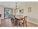 Spacious dining room with hardwood floors, sliding glass doors, and modern light fixture at 13450 E Via Linda -- # 2022, Scottsdale, AZ 85259