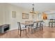 Formal dining area featuring hardwood floors, modern chandelier, and seating for eight at 13450 E Via Linda -- # 2022, Scottsdale, AZ 85259