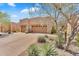 Attractive home exterior with desert landscaping highlighting the three-car garage and desert foliage at 13450 E Via Linda -- # 2022, Scottsdale, AZ 85259