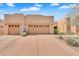 Attached three car garage with decorative stone accents and concrete driveway at 13450 E Via Linda -- # 2022, Scottsdale, AZ 85259