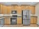 Modern kitchen showcases stainless steel appliances, granite countertops, and wooden cabinetry at 13450 E Via Linda -- # 2022, Scottsdale, AZ 85259