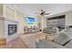 Cozy living room with a fireplace, a ceiling fan, and a flat screen tv for entertaining at 13450 E Via Linda -- # 2022, Scottsdale, AZ 85259