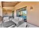 Cozy patio with comfortable seating and sliding glass doors to the home's interior at 13450 E Via Linda -- # 2022, Scottsdale, AZ 85259