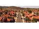 An aerial view showcases a residential neighborhood with red-tiled roofs and desert landscaping at 14418 S 42Nd St, Phoenix, AZ 85044