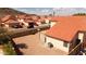 An elevated view of a community with red-tiled roofs and desert landscaping with mountain views in the distance at 14418 S 42Nd St, Phoenix, AZ 85044