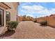Large gravel backyard featuring a covered patio and block wall for privacy at 14418 S 42Nd St, Phoenix, AZ 85044