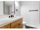 Modern bathroom with wood vanity, white countertop, and stylish black and white flooring at 14418 S 42Nd St, Phoenix, AZ 85044
