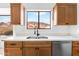 Modern kitchen sink with stainless steel appliances, quartz countertops, and a window view at 14418 S 42Nd St, Phoenix, AZ 85044