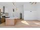 A modern living area showcasing the flow from the kitchen featuring wood flooring and vaulted ceilings at 14418 S 42Nd St, Phoenix, AZ 85044