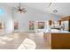 Bright, open-concept living room with wood floors, vaulted ceiling, and updated kitchen at 14418 S 42Nd St, Phoenix, AZ 85044