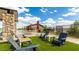 Relaxing community area with outdoor seating, artificial grass, and a shaded ramada near a grilling station at 14657 W Sand Hills Rd, Surprise, AZ 85387