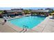 Beautiful community pool with lounge chairs, umbrellas, and ramada at 14657 W Sand Hills Rd, Surprise, AZ 85387