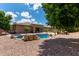 Backyard view featuring a large pool, desert landscaping, and a covered patio perfect for outdoor entertaining at 15088 W Coolidge St, Goodyear, AZ 85395