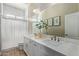 Bright bathroom features a double sink vanity and shower at 15088 W Coolidge St, Goodyear, AZ 85395