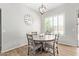 Cozy dining area with round table, neutral chairs, and a window with natural light at 15088 W Coolidge St, Goodyear, AZ 85395