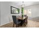 Dining area showcasing a wooden table, upholstered chairs, and decorative mirror at 15088 W Coolidge St, Goodyear, AZ 85395