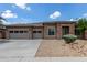 Beautiful single-Gathering home with stone accents and a spacious three-car garage on a sunny day at 15088 W Coolidge St, Goodyear, AZ 85395