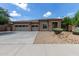Beautiful single-Gathering home with stone accents and a spacious three-car garage on a sunny day at 15088 W Coolidge St, Goodyear, AZ 85395