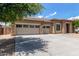 Well-maintained single-Gathering home with a spacious three-car garage and mature tree shading the driveway at 15088 W Coolidge St, Goodyear, AZ 85395