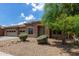 Charming single-Gathering home featuring a well-maintained front yard with desert landscaping and stone accents at 15088 W Coolidge St, Goodyear, AZ 85395