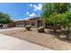 Charming single-Gathering home featuring a well-maintained front yard with desert landscaping and stone accents at 15088 W Coolidge St, Goodyear, AZ 85395