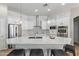 Stylish kitchen with white cabinets, stainless steel appliances, and quartz island with seating at 15088 W Coolidge St, Goodyear, AZ 85395