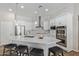 Modern kitchen featuring white cabinets, stainless steel appliances, and a quartz countertop island at 15088 W Coolidge St, Goodyear, AZ 85395