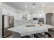 Bright kitchen with white cabinetry, subway tile backsplash, and stainless steel appliances at 15088 W Coolidge St, Goodyear, AZ 85395