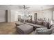 Open-concept living room with modern kitchen, dining area, and plush sectional sofa at 15088 W Coolidge St, Goodyear, AZ 85395